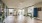 a room with a wood floor and glass walls