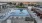 pool area with reclining seats and landscaping