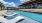 a swimming pool with lounge chairs
